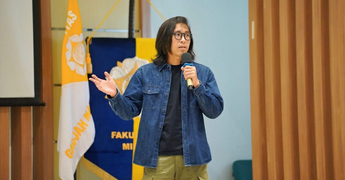 dr. Tirta sedang memberikan presentasi di depan audiens di suatu acara seminar.