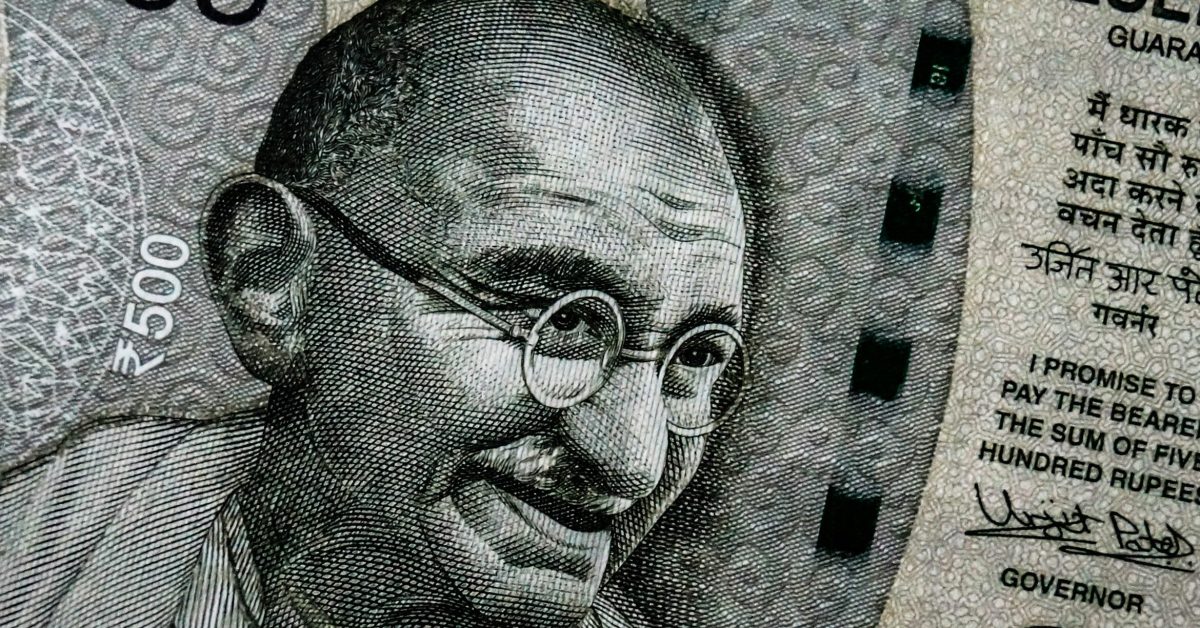 Gambar close-up uang kertas pecahan ₹500 India dengan gambar Mahatma Gandhi.